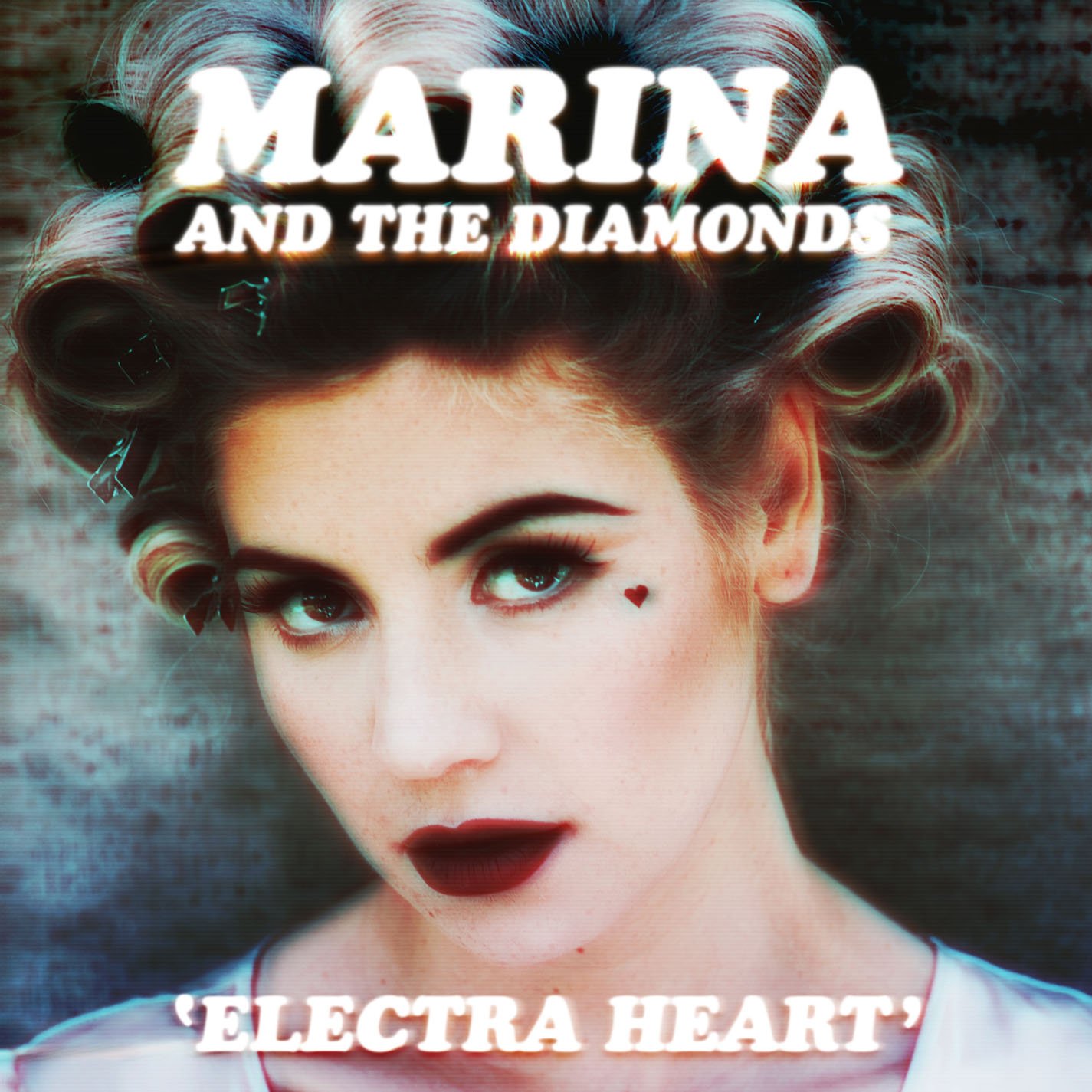 An image of the cover of the album 'Electra Heart', showing a young woman wearing hair rollers, with a small heart drawn with makeup just below her left eye, as if a tear.