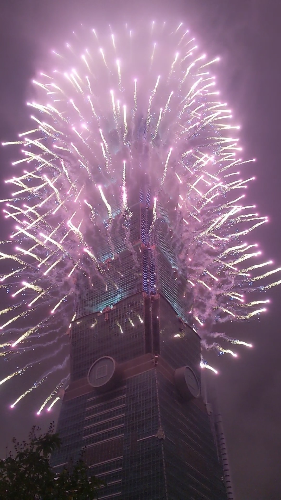 A photo of fireworks shooting off Taipei 101.
